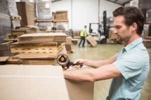 Man taping a packaging box